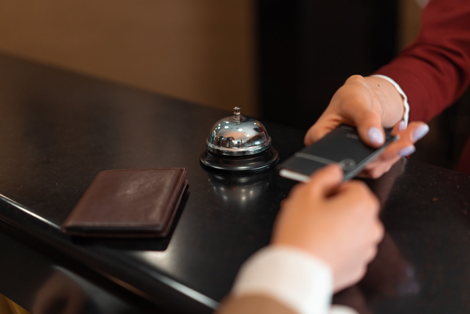 A guest receiving a room key at a hotel desk